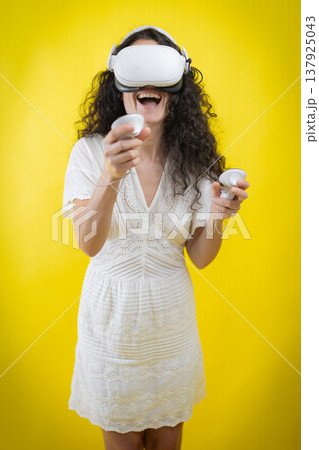 Woman experiencing virtual reality enjoying immersive media concept Woman experiencing virtual reality enjoying immersive media concept 137925043