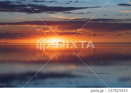 Peaceful sunset reflection over salt flat landscape in Uyuni Bolivia 137925633