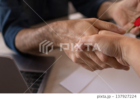 Close-up of the hands of a real state agent at his client making an agreement by shaking hands Close-up of the hands of a real state agent at his client making an agreement by shaking hands 137927224