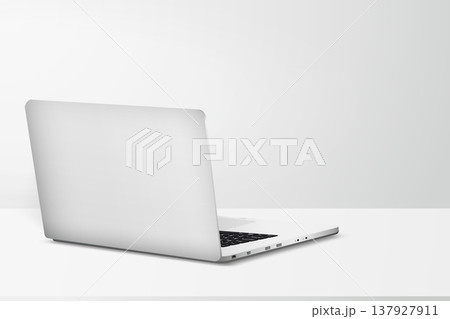 Minimal workspace with laptop back side view on table with gray wall background 137927911