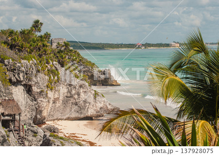Tulum Mayan ruins overlooking the turquoise Caribbean Sea with crashing waves on the white sand beach, creating a stunning Mexican travel destination scene Tulum Mayan ruins overlooking the turquoise Caribbean Sea with crashing waves on the white sand beach, creating a stunning Mexican travel destination scene 137928075