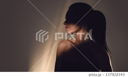 Silhouette woman with long earrings in soft gradient studio lighting profile. Silhouette woman with long earrings in soft gradient studio lighting profile. 137928343