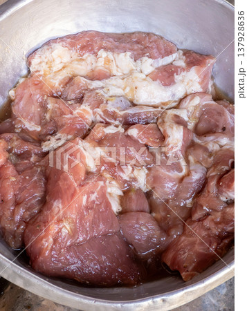 Marinated Pork Neck Meat in Metal Bowl Prepared for Grill. Marinated Pork Neck Meat in Metal Bowl Prepared for Grill. 137928636