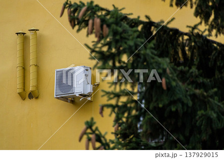 air conditioning on facade of building, air cooling in hot weather. air conditioning on facade of building, air cooling in hot weather. 137929015
