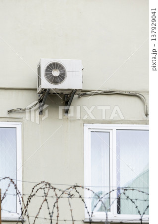 air conditioning on facade of building, air cooling in hot weather. air conditioning on facade of building, air cooling in hot weather. 137929041