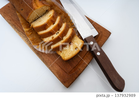 Pound cake slices on wooden board with knife Pound cake slices on wooden board with knife 137932989