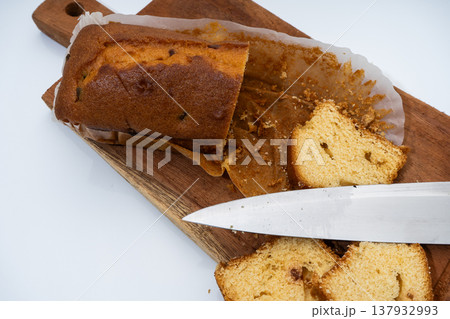 Slicing pound cake on wooden board 137932993