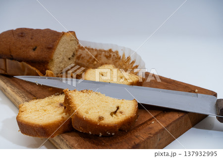 Pound cake loaf slicing on wooden cutting board Pound cake loaf slicing on wooden cutting board 137932995