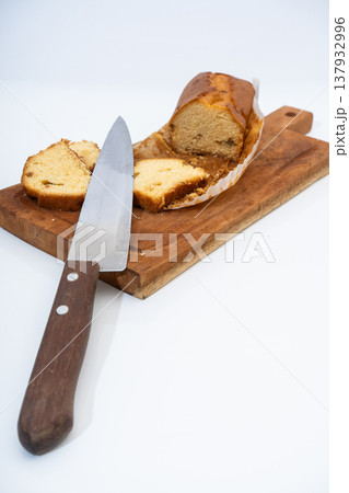 Slicing pound cake on wooden board for breakfast Slicing pound cake on wooden board for breakfast 137932996