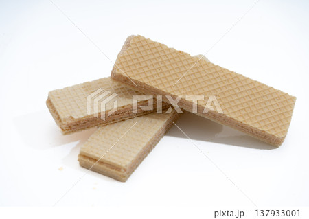 Wafers stacked on white background with cream filling 137933001