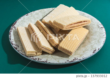 Cream filled wafers on a plate offering sweet snack 137933012