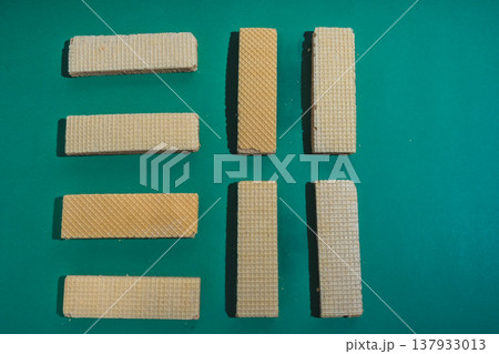 Sweet rectangular wafers arranged on green background Sweet rectangular wafers arranged on green background 137933013