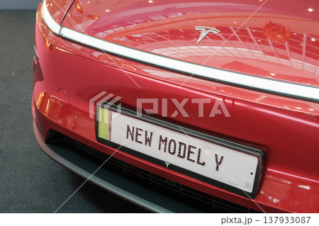 Tesla Model Y in red with sleek design displayed at exhibition Tesla Model Y in red with sleek design displayed at exhibition 137933087