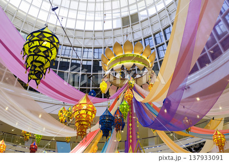 Colorful deepavali celebration featuring lanterns and decorative drapes in a festive setting Colorful deepavali celebration featuring lanterns and decorative drapes in a festive setting 137933091