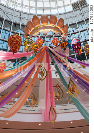 Colorful Deepavali celebration decor with lanterns and drapes adorning a modern indoor space Colorful Deepavali celebration decor with lanterns and drapes adorning a modern indoor space 137933092