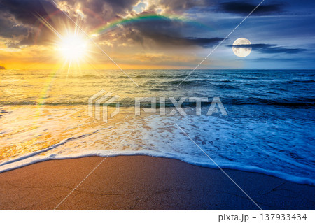 vacation at the sea on autumn equinox. day meet night. sun and moon over beautiful seascape. waves wash the sandy beach. image with epic sky above horizon. background for relaxation or ads placement 137933434