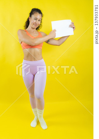 Woman holding and pointing at blank paper 137933781