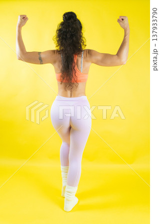 Woman flexing muscles demonstrating strength and fitness 137933790