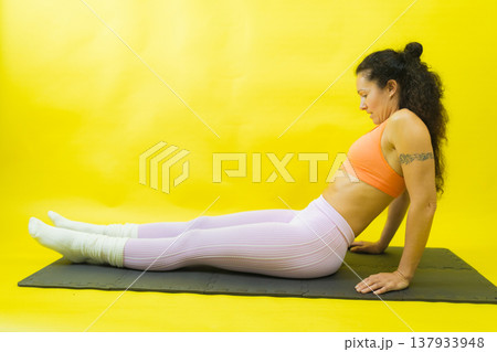 Woman exercising core muscles on fitness mat Woman exercising core muscles on fitness mat 137933948