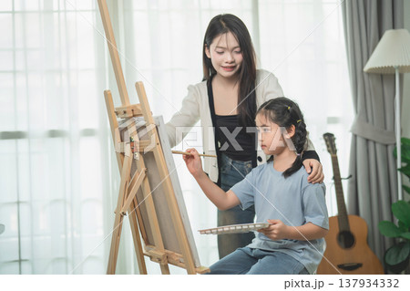Mother and Daughter Engaged in Painting Activity at Home, Artistic Bonding Experience, Creativity and Learning Moments, Family Time Together Mother and Daughter Engaged in Painting Activity at Home, Artistic Bonding Experience, Creativity and Learning Moments, Family Time Together 137934332