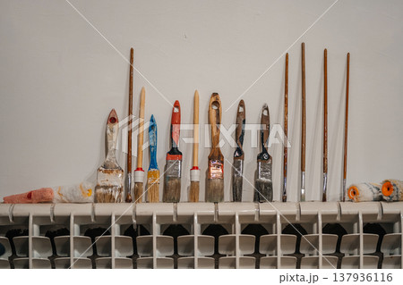 Creative Studio With Aged Brushes. Artistic Supplies Displayed Thoughtfully On Wellused Shelf 137936116