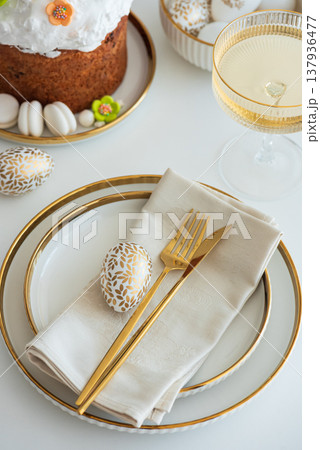 Elegant Easter Table Setting with Decorative Egg and Spring Details 137936477