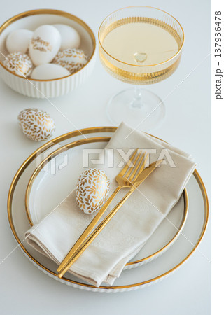 Elegant Easter Table Setting with Decorative Egg and Spring Details 137936478