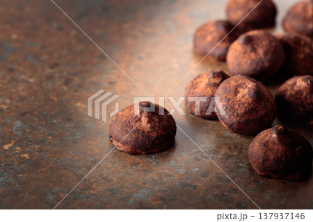 Chocolate truffles on a rusty background. 137937146