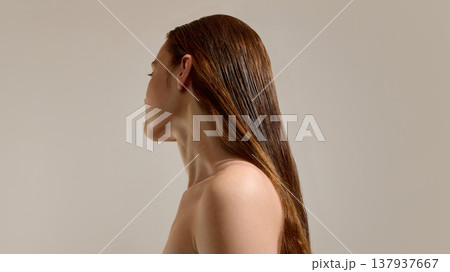 Woman with long hair after treatment on neutral background. Woman with long hair after treatment on neutral background. 137937667