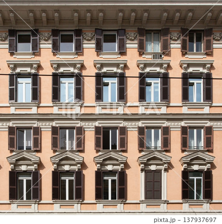Residential building facade with many windows and shutters Residential building facade with many windows and shutters 137937697