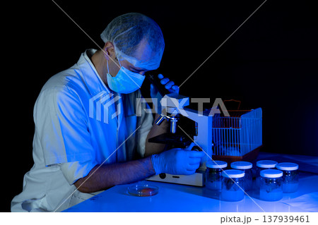 The scientist biologist is working very seriously use microscope The scientist biologist is working very seriously use microscope 137939461