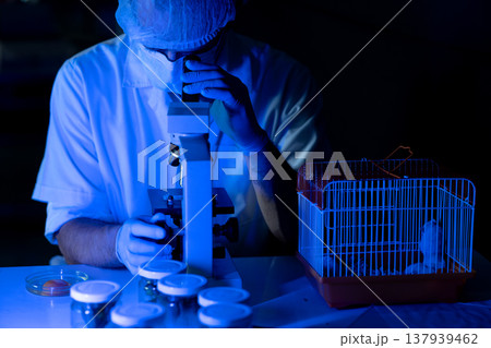 The scientist biologist is working very seriously use microscope The scientist biologist is working very seriously use microscope 137939462