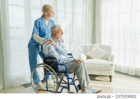 Help support retirement healthcare. Nurse helping old man in wheelchair. Patient and woman in nursing home for medical caregiver. Nurse taking care of paralyzed man in chair for people with disability Help support retirement healthcare. Nurse helping old man in wheelchair. Patient and woman in nursing home for medical caregiver. Nurse taking care of paralyzed man in chair for people with disability 137939802