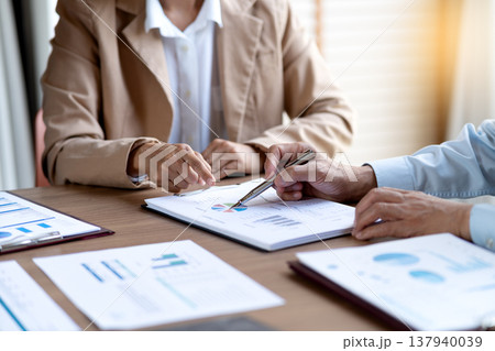 businesswoman is pointing to marketing and management datasheets team brainstorm businesswoman is pointing to marketing and management datasheets team brainstorm 137940039