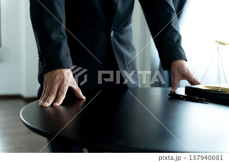 Lawyer standing putting both hands on the table Lawyer standing putting both hands on the table 137940081