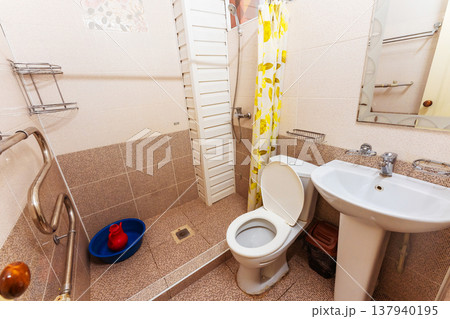 Small Bathroom With Maintenance Features. Cozy Tiled Restroom With Fixtures And Accessories Small Bathroom With Maintenance Features. Cozy Tiled Restroom With Fixtures And Accessories 137940195