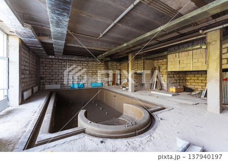 Derelict Basin With Structural Elements. Empty Swimming Area With Exposed Beams And Debris Derelict Basin With Structural Elements. Empty Swimming Area With Exposed Beams And Debris 137940197