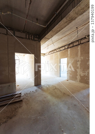 Architect Reviews Building Plans. Unfinished Corridor With Construction Details Exposed Architect Reviews Building Plans. Unfinished Corridor With Construction Details Exposed 137940199