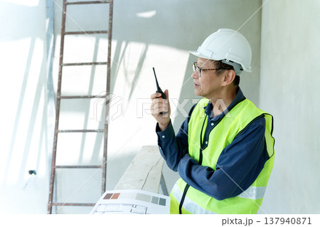 construction site manager is using radio to order construction 137940871