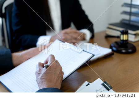 Lawyers talking to a team of women in Law firm Lawyers talking to a team of women in Law firm 137941221