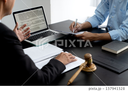 Lawyer explaining planned legal work to assistant to prepare documents Lawyer explaining planned legal work to assistant to prepare documents 137941328
