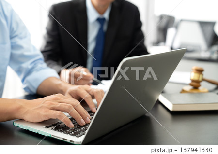 Lawyers and assistants are helping each other down legal documents 137941330