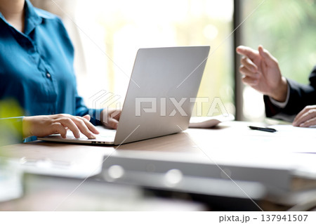 businessman giving a business lecture to a young businesswoman in business businessman giving a business lecture to a young businesswoman in business 137941507