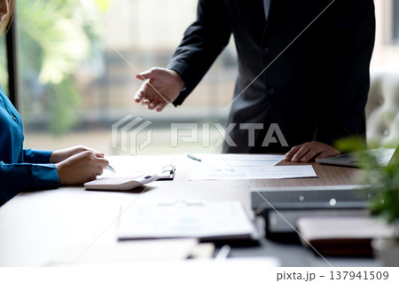 businessman executive is pointing with his hand for businesswoman businessman executive is pointing with his hand for businesswoman 137941509