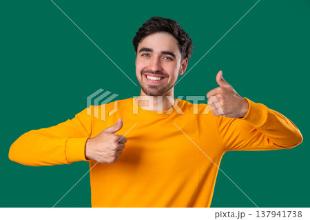 Handsome Man With Hand Sign Like, Thumbs Up Gesture.happy Guy On green Studio 137941738