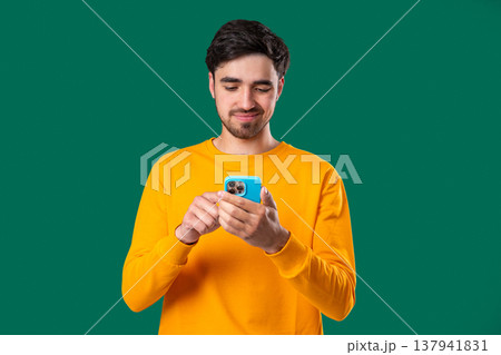 Bored Indifferent Man Scrolling Networks, Smartphone,Internet Addiction on Green Bored Indifferent Man Scrolling Networks, Smartphone,Internet Addiction on Green 137941831