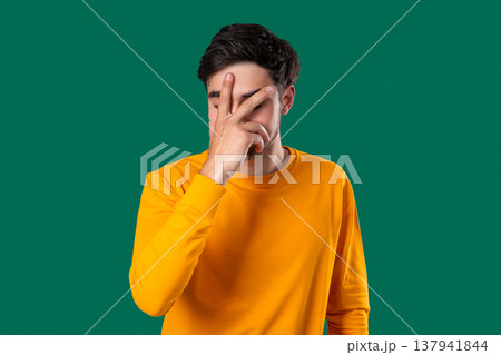 Disappointed young Man Doing Facepalm. Feeling Regret, Failure, Wasted Time Disappointed young Man Doing Facepalm. Feeling Regret, Failure, Wasted Time 137941844