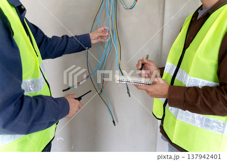 Foreman and supervisor are pointing out corrections and installation Foreman and supervisor are pointing out corrections and installation 137942401