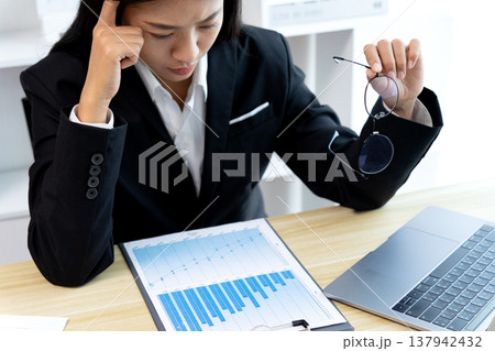 young business woman Seriously thinking while looking at company 137942432
