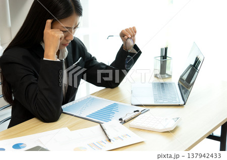 young business woman Seriously thinking while looking at company young business woman Seriously thinking while looking at company 137942433